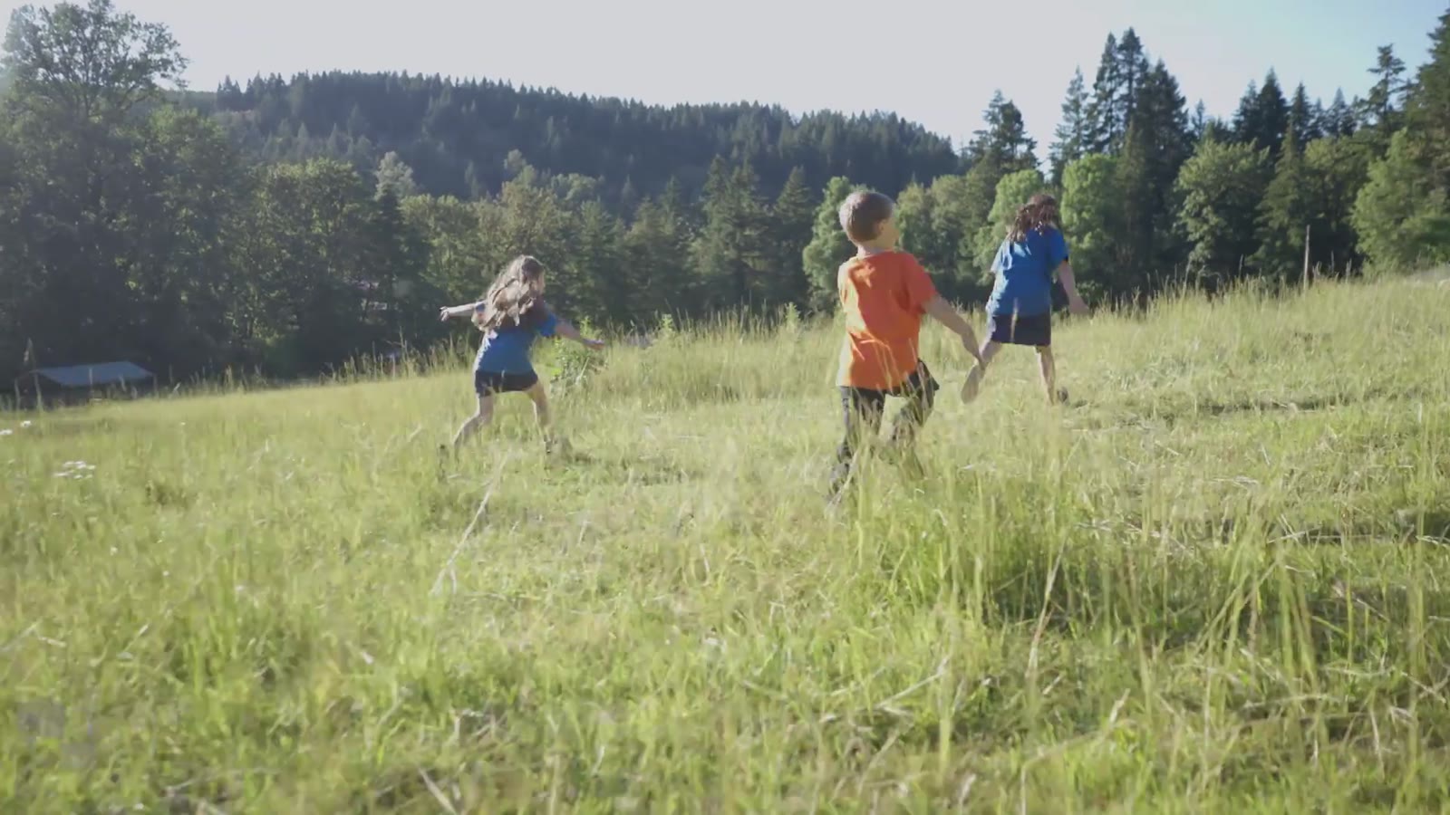 Cub Scouts running through a field in the Digital by DG anthem film